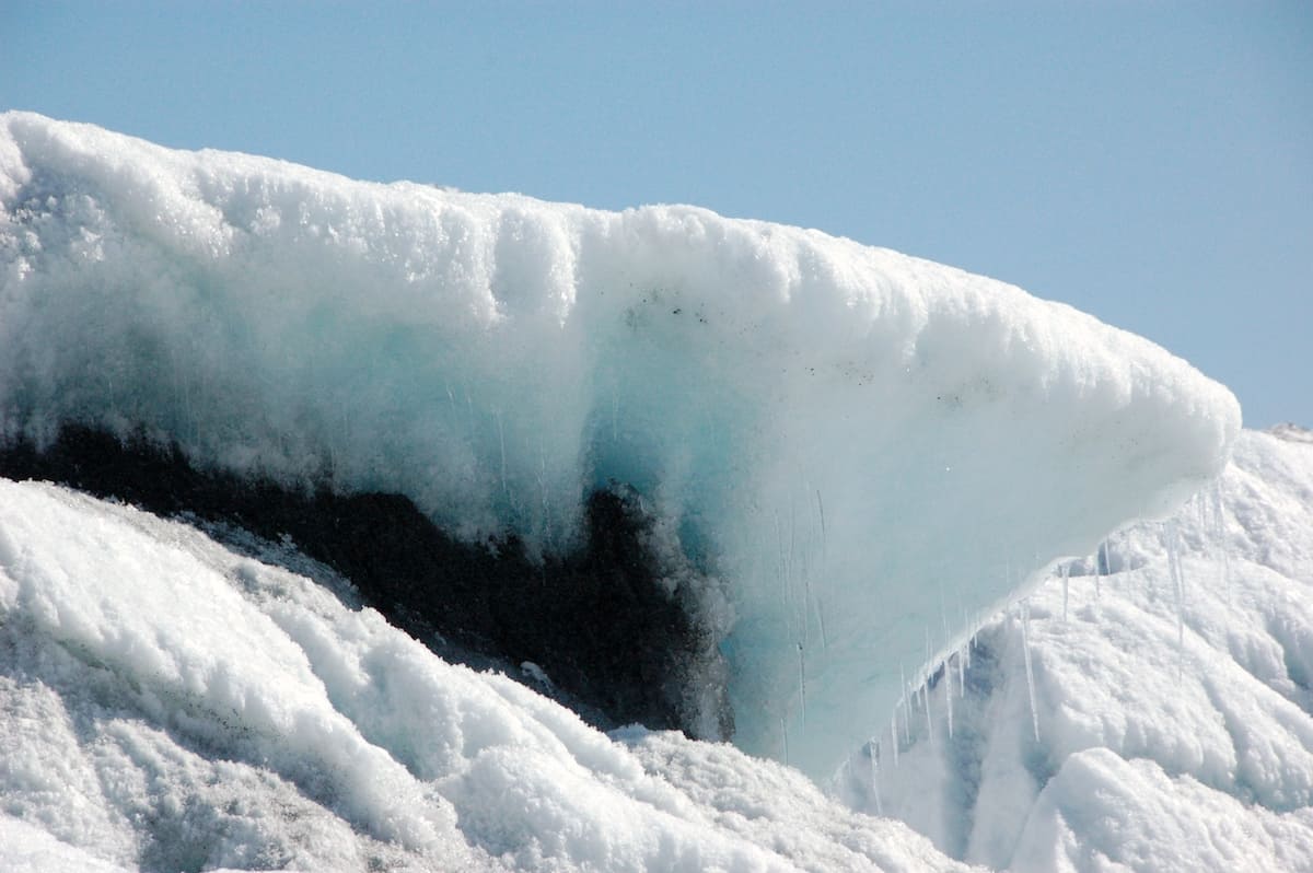 snow on blue tinted glacier