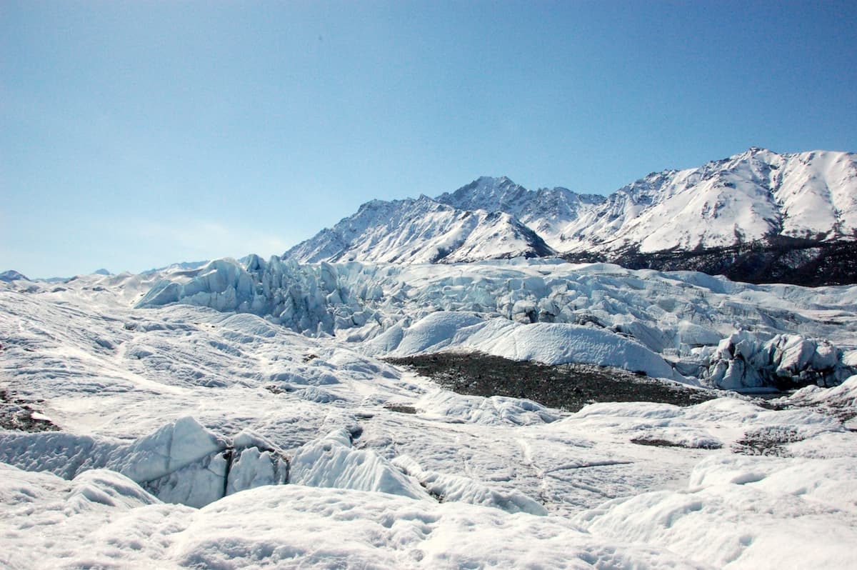 large glacier field with patches of brown dirt