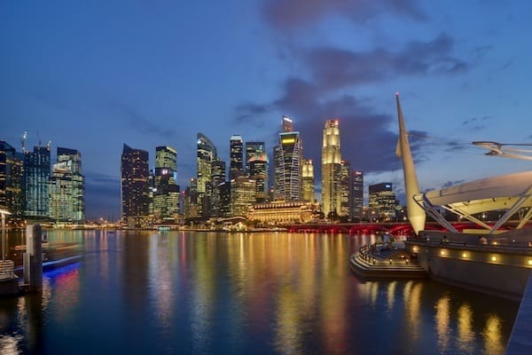 Singapore CBD skyline from Esplanade at dusk Traveling Well For Less