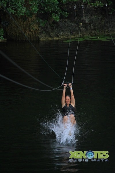 zip lining into the water at Lik Xenotes Oasis Maya Traveling Well For Less