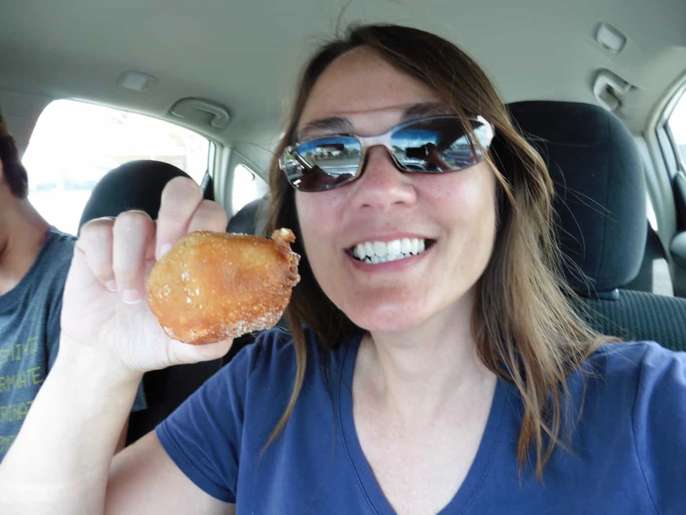 Eating malasadas in Hawaii Traveling Well For Less