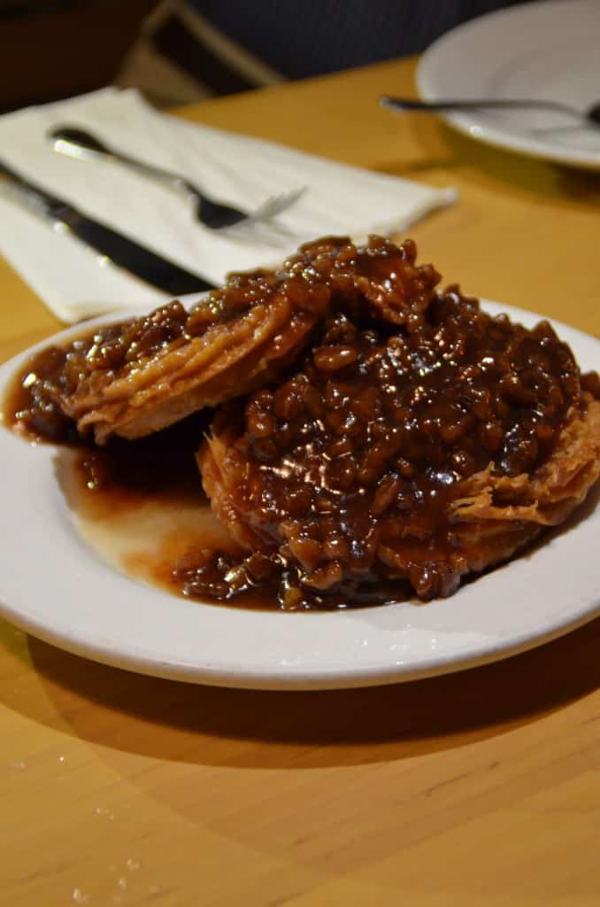 wo crunchy churros topped with a caramelized pecan sauce of raw pecans at Hugo's Restaurant. Traveling Well For Less