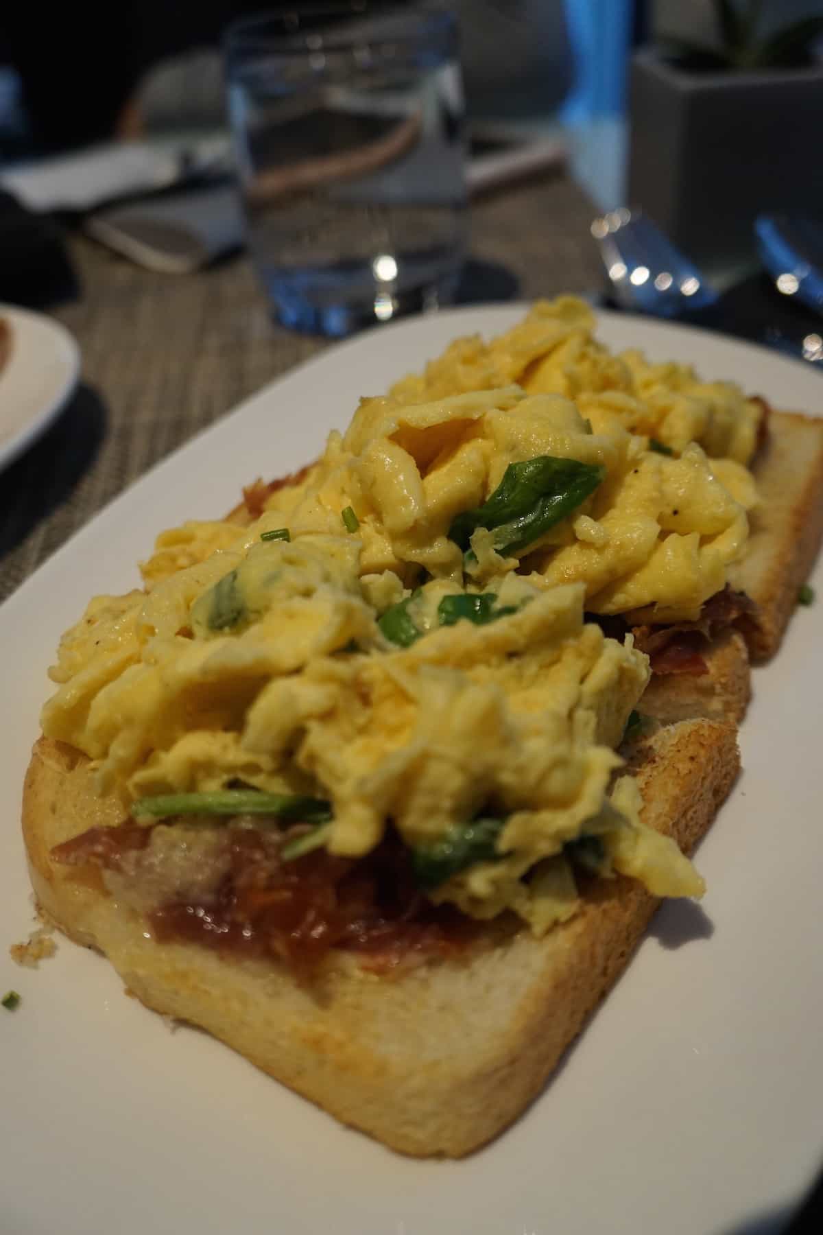 A choice of one of two hot a la carte egg options: open-faced toast with scrambled cage-free egg, manchego cheese, arugula and La Quercia Prosciutto | AC Hotel Columbus Dublin | TravelingWellForLess.com