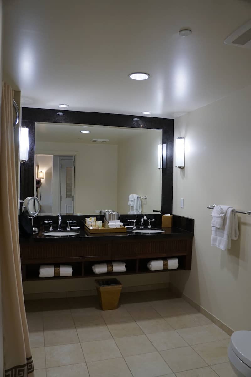 The dual sink Corian countertop in the bathroom lets two people get ready at the same time. There's just enough room to the sides of the sink for your toiletries. | Santa Barbara | Where to stay in Santa Barbara | Santa Barbara beachfront hotel | California | American Riveria | www.TravelingWellForLess.com