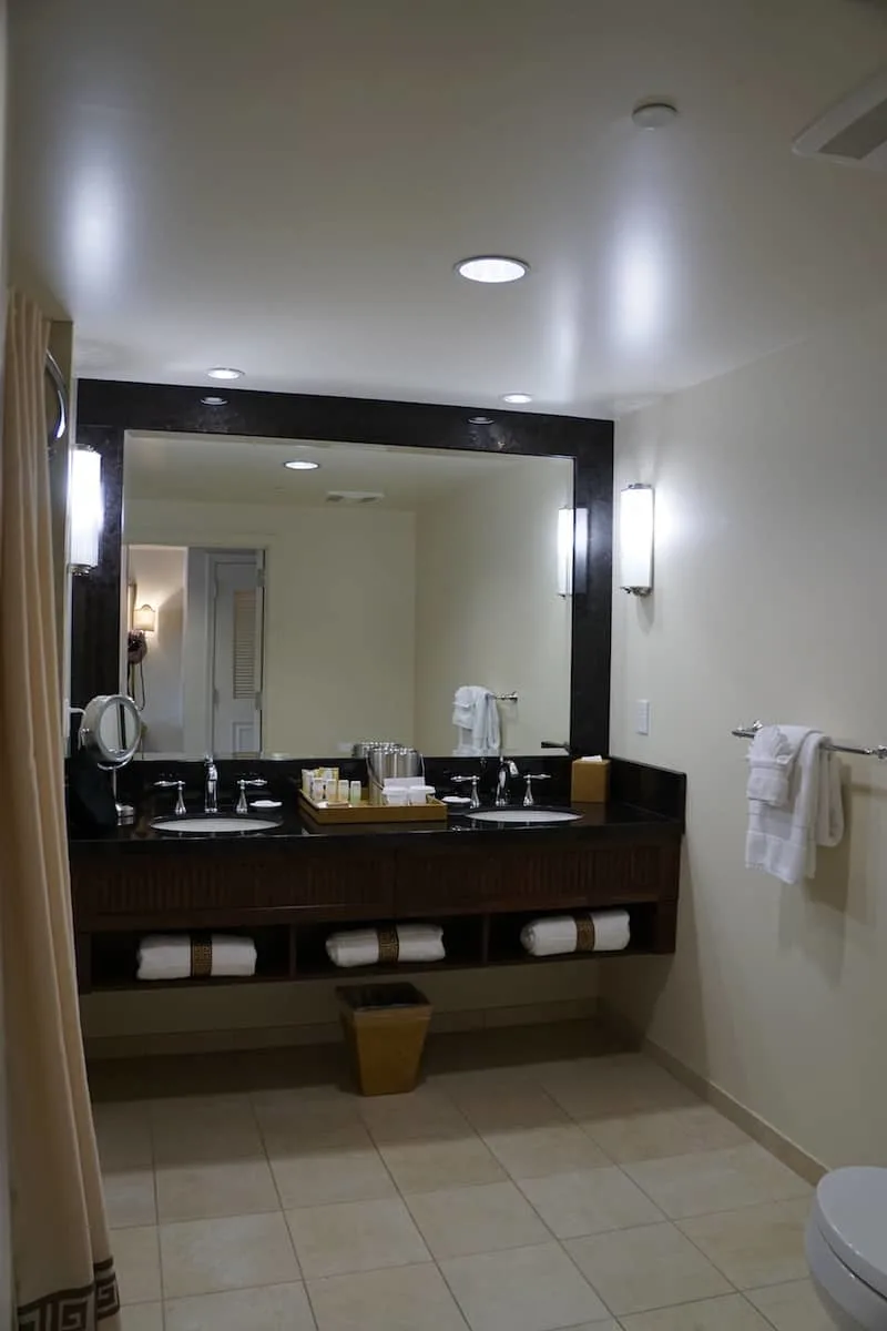 The dual sink Corian countertop in the bathroom lets two people get ready at the same time. There's just enough room to the sides of the sink for your toiletries. | Santa Barbara | Where to stay in Santa Barbara | Santa Barbara beachfront hotel | California | American Riveria | www.TravelingWellForLess.com