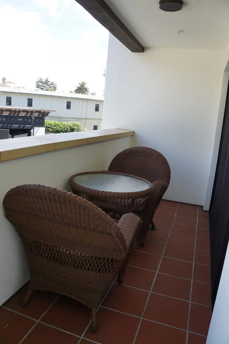 A small table with two chairs on the Spanish tiled balcony make for an al fresco breakfast, lunch, or snack. | Santa Barbara | Where to stay in Santa Barbara | Santa Barbara beachfront hotel | California | American Riveria | www.TravelingWellForLess.com