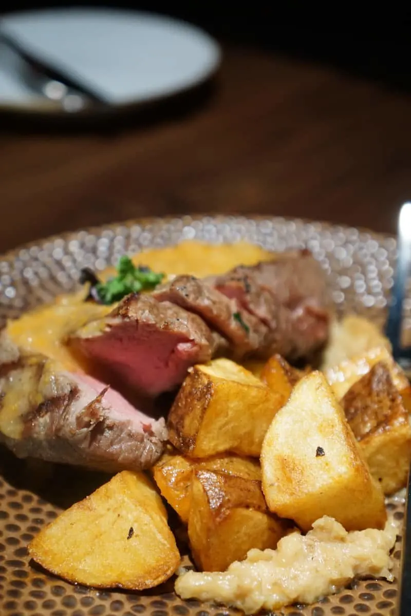 Looking for a meat and potato dish? The flavorful Entrana Con Salsa Vizcaina (hanger steak with a sweet red choricero pepper sauce) with roasted potatoes is sure to please meat lovers.  | Dublin, Ohio | Columbus | Spanish food | where to eat in Columbus | TravelingWellForLess.com