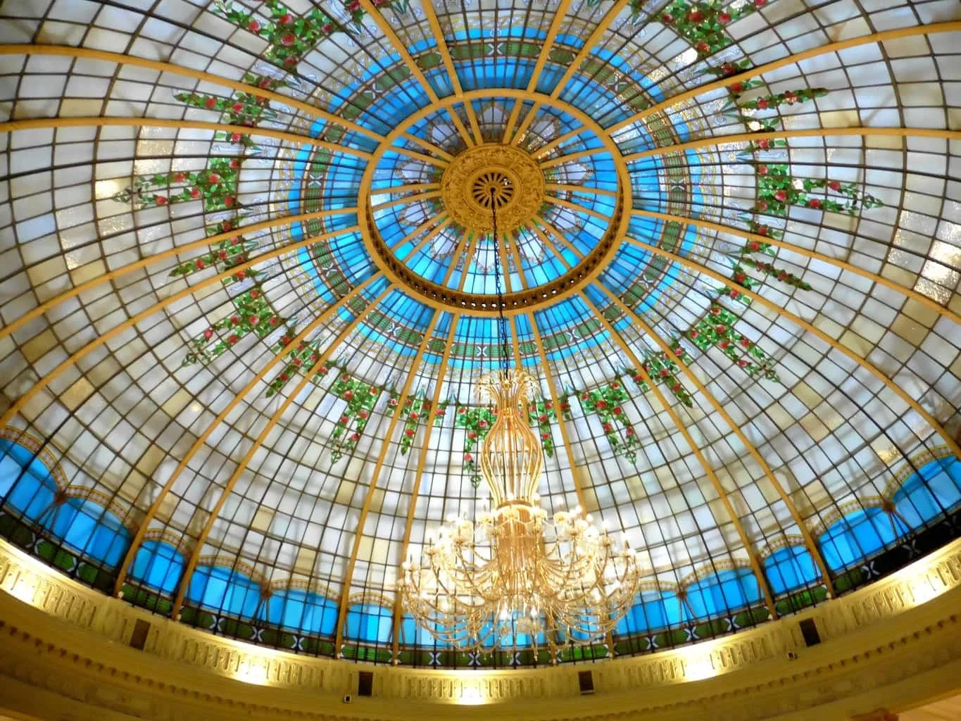 The stained glass domed ceiling of La Rotonda Westin Palace Madrid is worth seeing. TravelingWellForLess.com