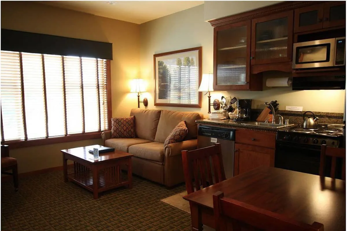 Living area and kitchen in Homestead Resort room. The Homestead Resort offers 30 studio, 1 bedroom, and 2 bedroom suites on the golf course overlooking the lake. #lynden #washington #travel #hotel https://www.travelingwellforless.com