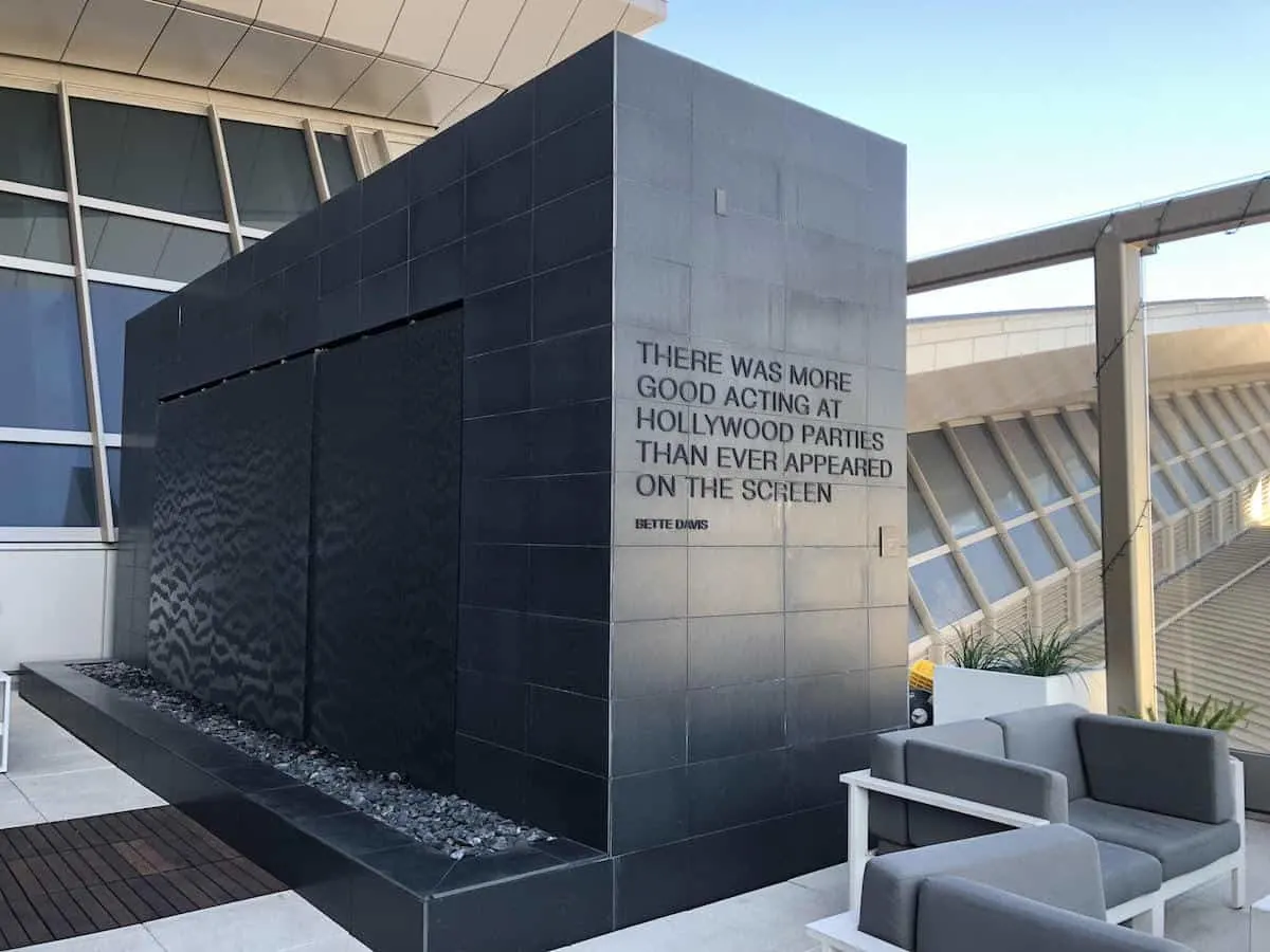 Quote from Bette Davis on water wall at the Star Alliance Business Class Lounge LAX outside terrace