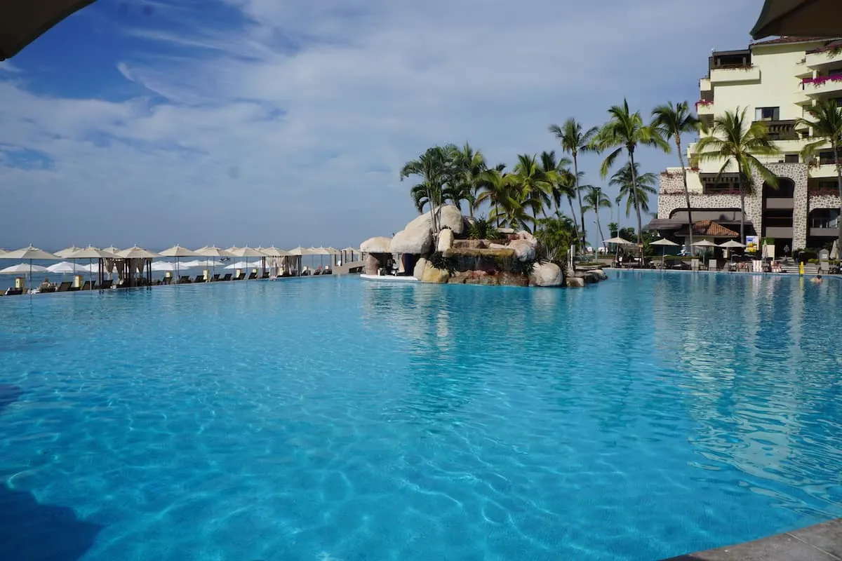 Take a dip in the infinity pool while enjoying stunning views of Banderas Bay. The swim-up bar and pool attendants will ensure that you stay hydrated. | Marriott Puerto Vallarta Resort & Spa | where to stay in Puerto Vallarta | www.TravelingWellForLess.com