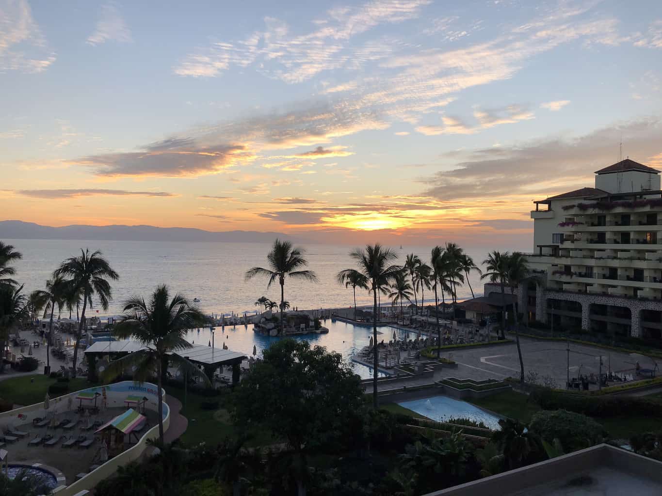 Imagine lounging on your private balcony, taking in the view of the ocean while enjoying the sunset. | Marriott Puerto Vallarta Resort & Spa | where to stay in Puerto Vallarta | www.TravelingWellForLess.com