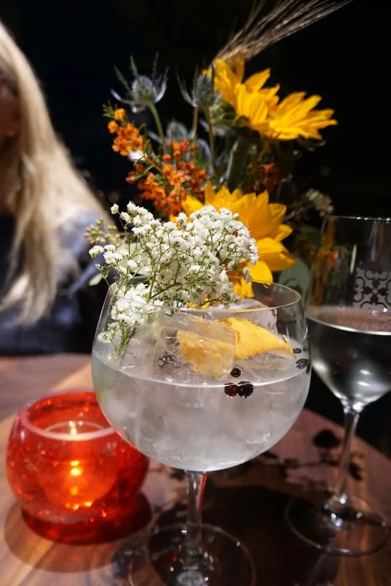 VASO Rooftop Lounge gin and tonic. VASO Rooftop Lounge G&T corsage baby breath. An unbelievable gin & tonic. Made with Four Peels gin from Columbus' own Watershed Distillery| Dublin, Ohio | Columbus | Spanish food | where to eat in Columbus | TravelingWellForLess.com