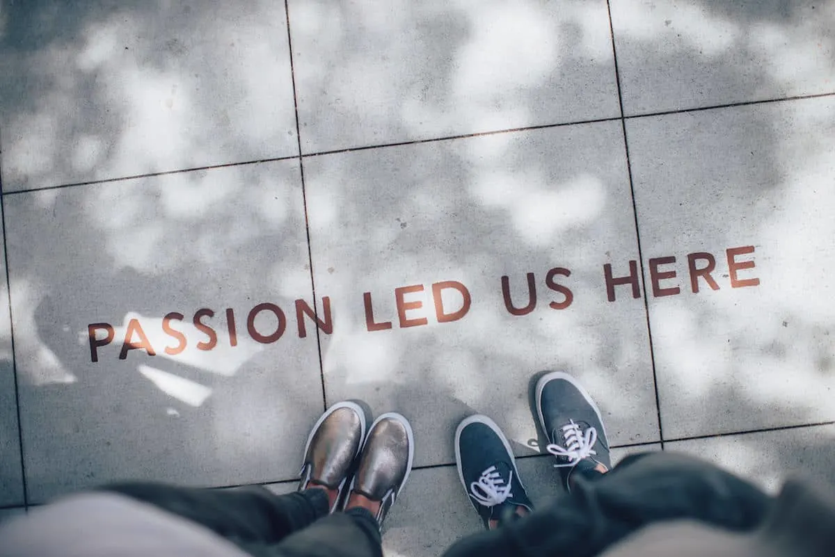 the words passion led us here on a sidewalk