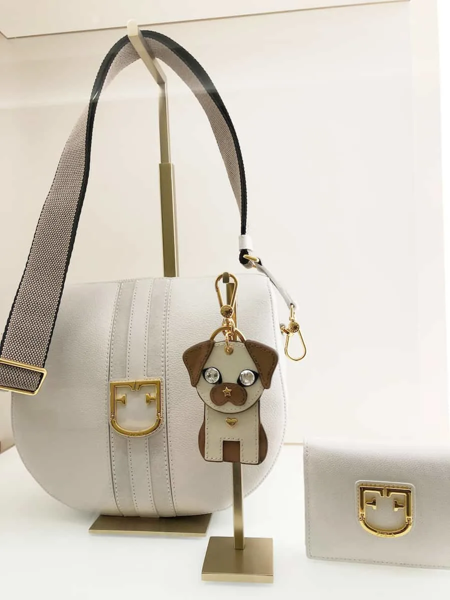 Furla Gioia crossbody bag, Furla Belvedere bi-fold wallet, and Furla dog keyring at South Coast Plaza, one of the best things to do in Costa Mesa
