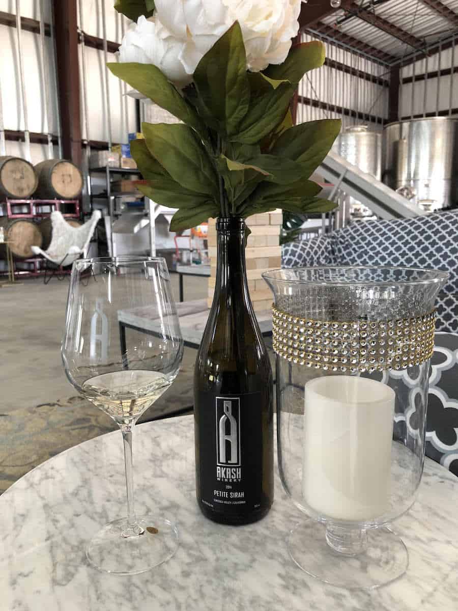 Akash's boring shed tasting room hides an Instagram friendly interior featuring intriguing decor such as faux fur spectator chairs. Akash offers a Cabernet Sauvignon, Parlez Vous Rose, Petite Sirah, and a Sauvignon Blanc. | fun things to do in Temecula | things to do in Temecula | Riverside County | https://www.travelingwellforless.com