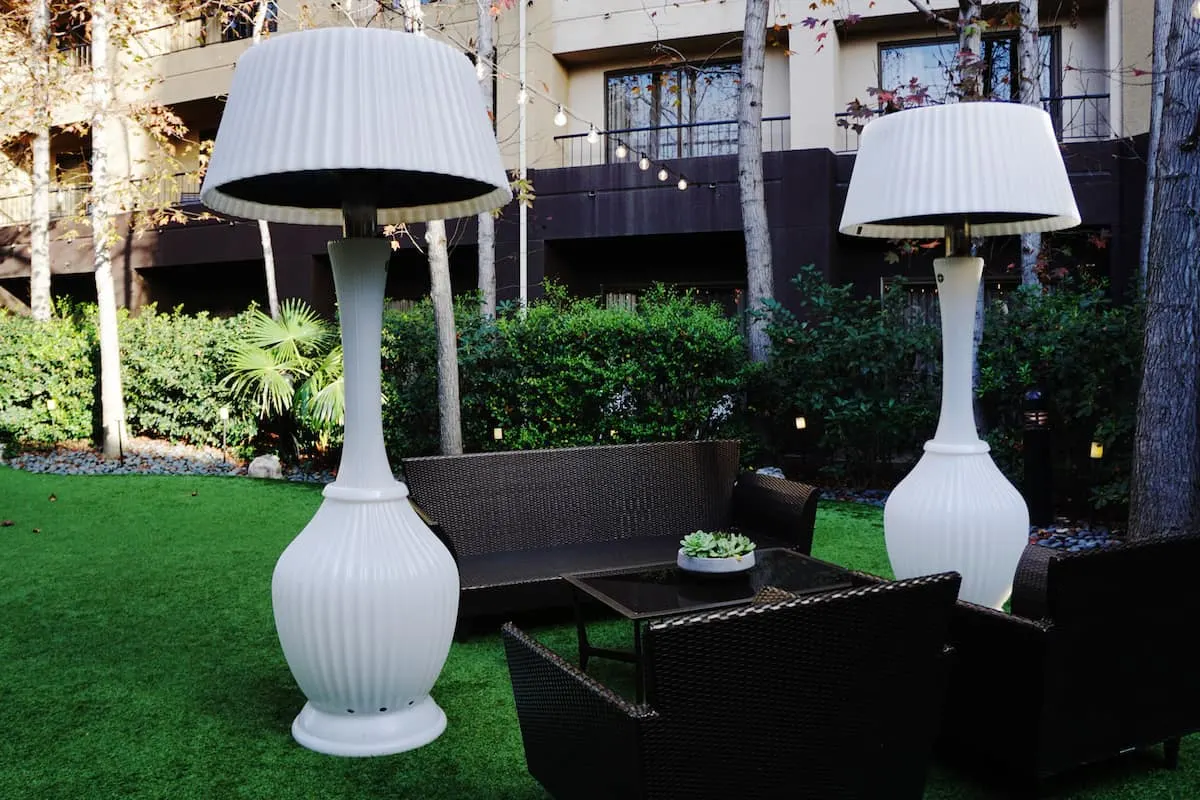 Giant faux lamps and wicker outdoor furniture in the Avenue of the Arts Costa Mesa garden