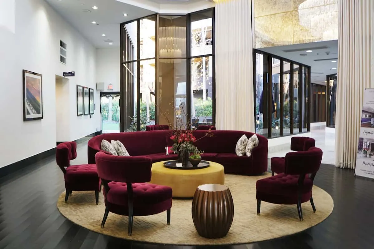 deep red almost burgundy velvet couch and matching chairs