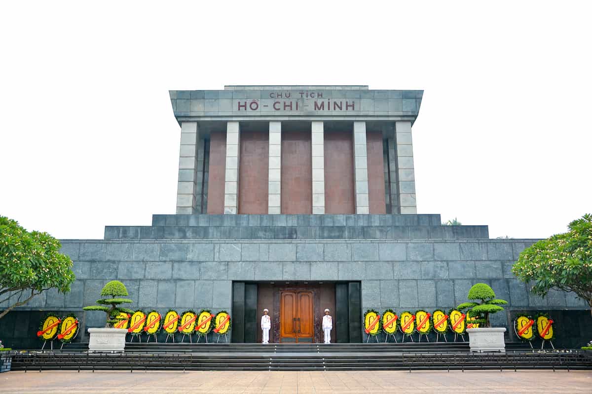 two guards and flower wreaths at front of Ho Chi Minh Mausoleum