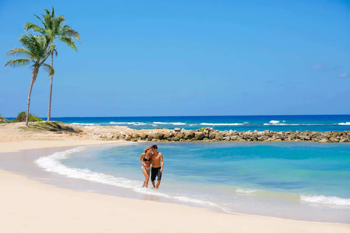 couple walking on beach in Caribbean