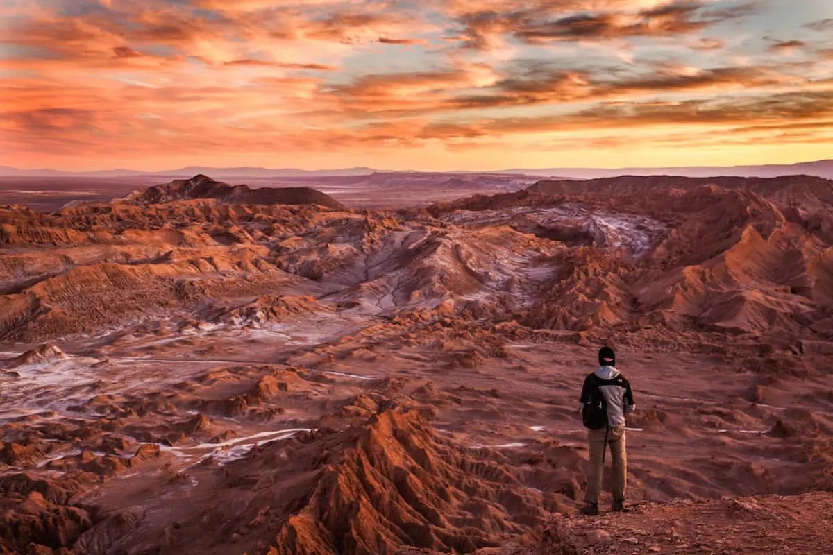 hiking man staring at sunrise in the outdoors