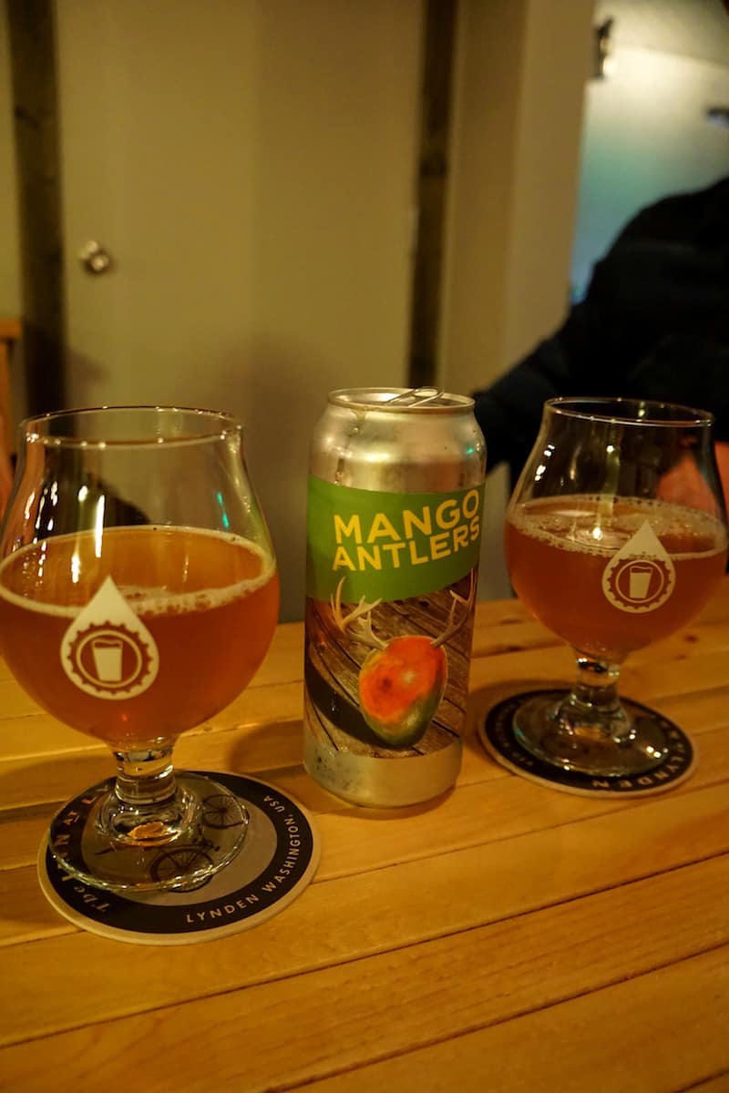 Two pint glasses and a can of Mango Antlers IPA. Overflow taps is your Lynden source for high-quality craft beer not found in the grocery stores. #craftbeer #thingstodoinLynden #Lynden #Washington