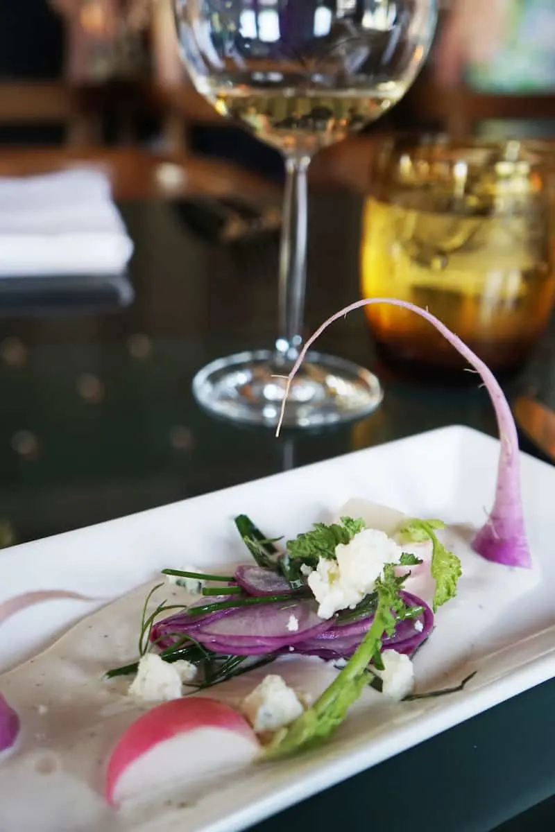 radishes in dressing on a white plate