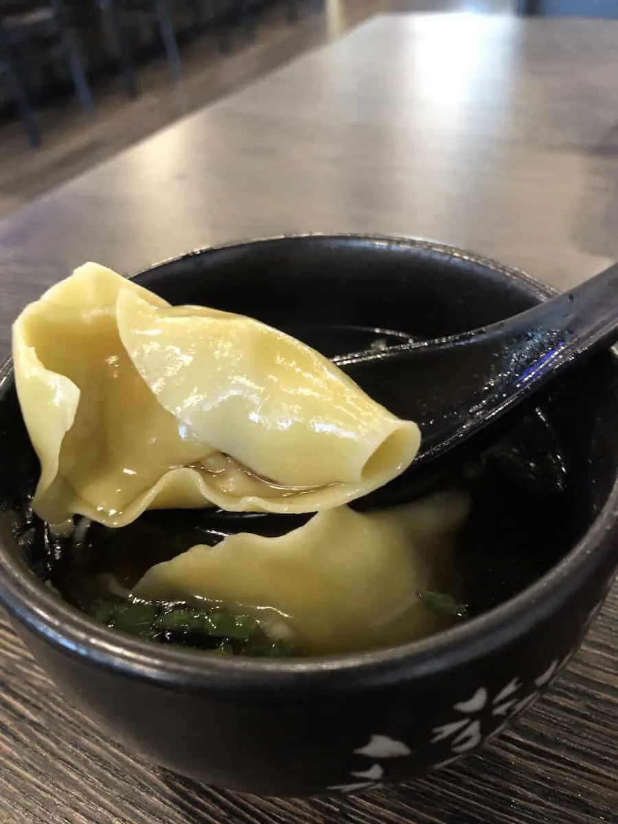 black bowl with two soup dumplings