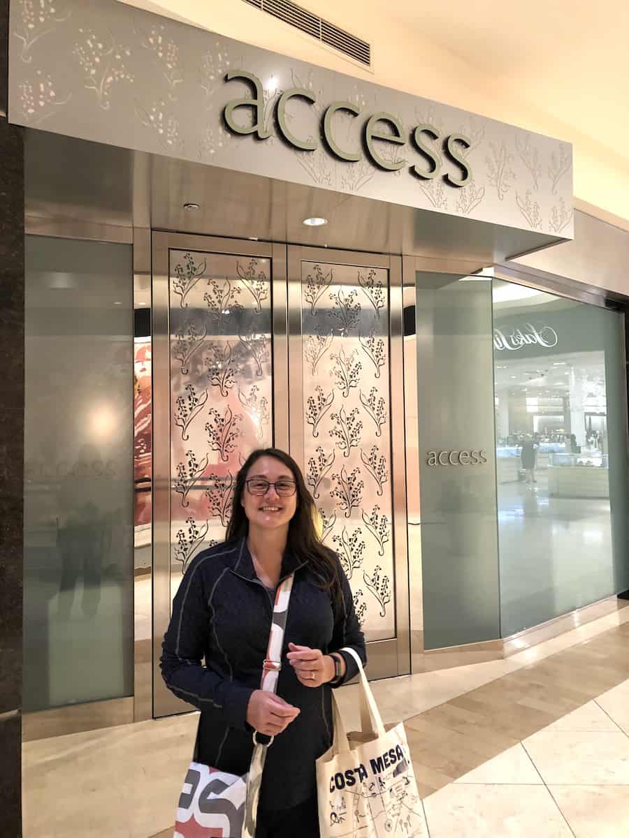 happy woman at entrance to acess suite lounge at south coast plaza