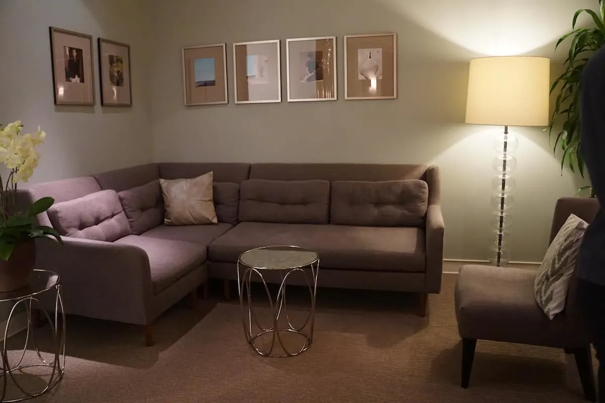 large soft purple sectional couch and chair at access suite lounge
