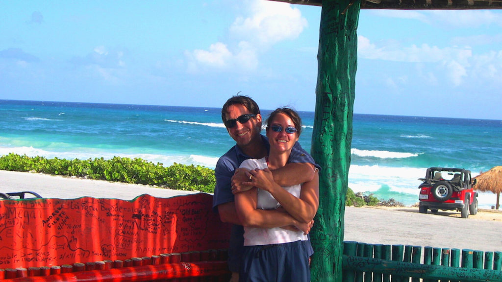 loving couple embracing in bar on white sand beach in Cozumel, Mexico