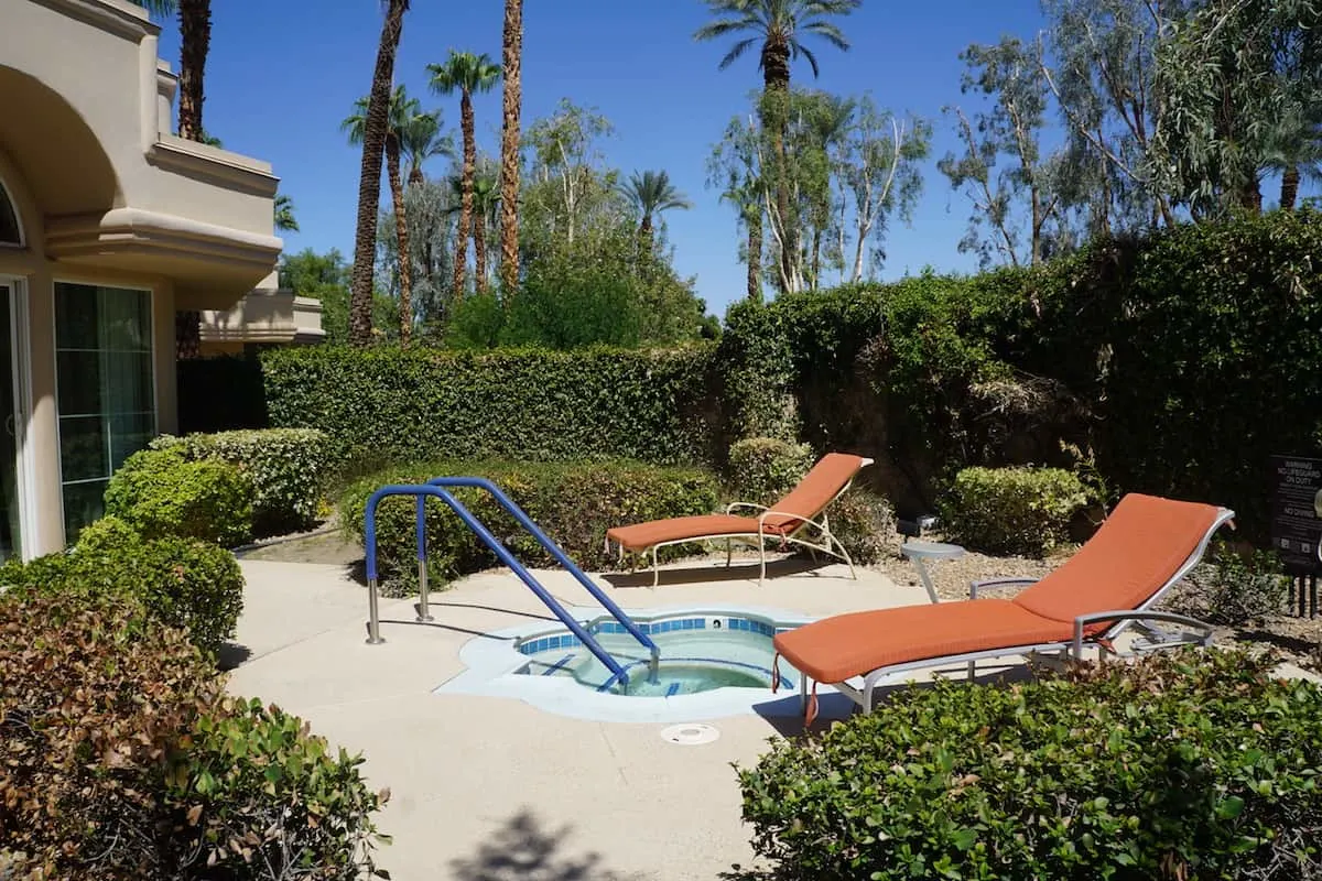 private spa tub and two lounge chairs