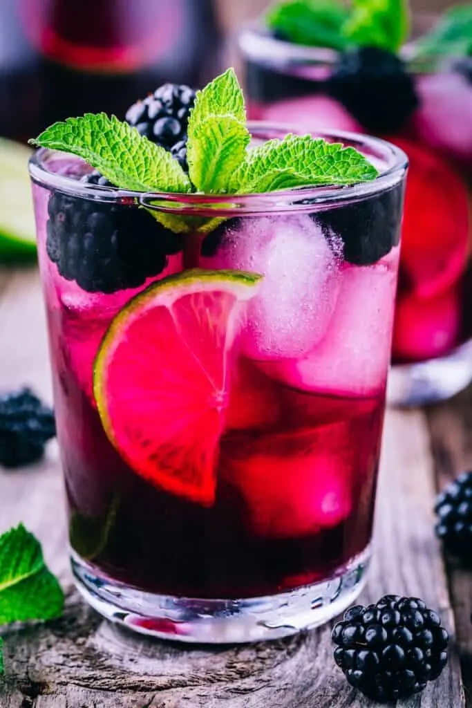 Blackberry smash cocktail with lime, mint and ice