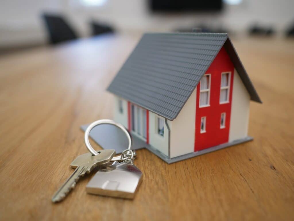 white and red wooden house miniature on brown table; earn miles and points without a credit card with  mortgage or refinance