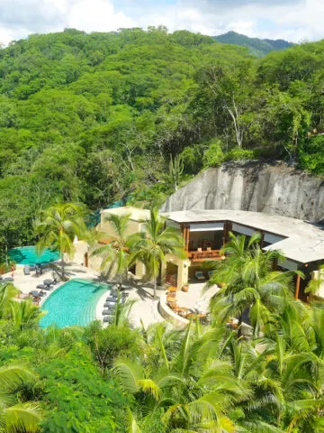 turquoise green resort infinity pool and spa surrounded by lush green trees