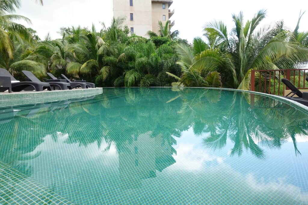 tiled infinity pool with palms trees
