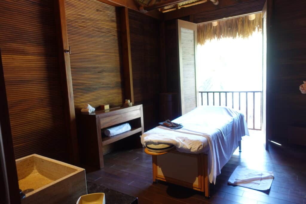 massage table in dark wood spa