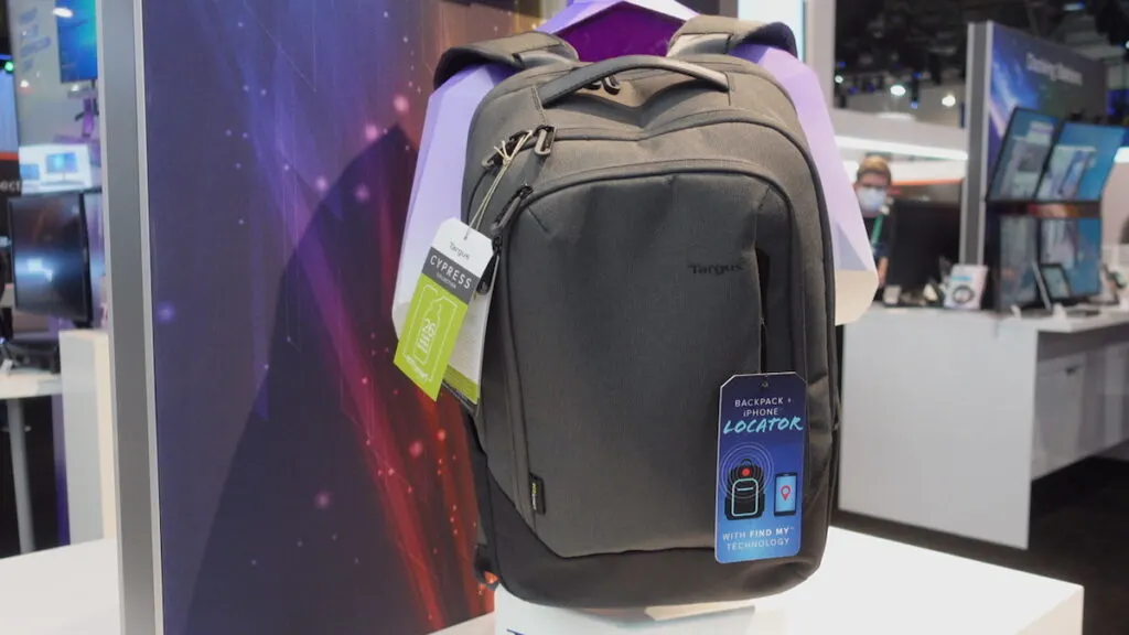 gray backback hanging in front of purple wall on show floor ces 2022