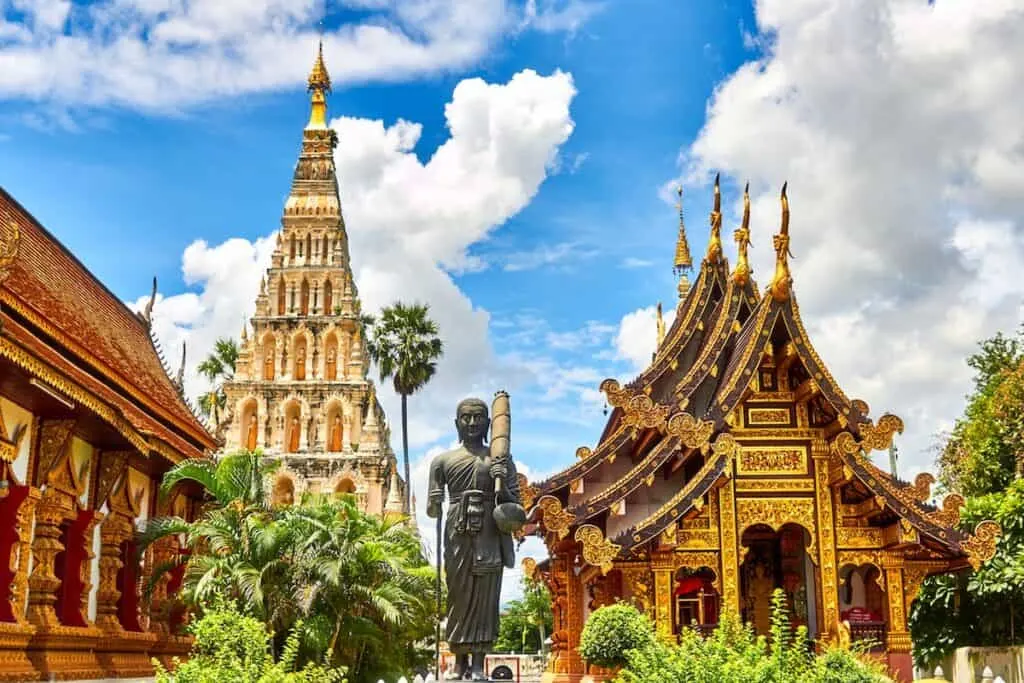 standing statue and temples landmark during daytime photo in Thailand