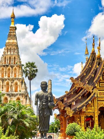 standing statue and temples landmark during daytime photo in Thailand