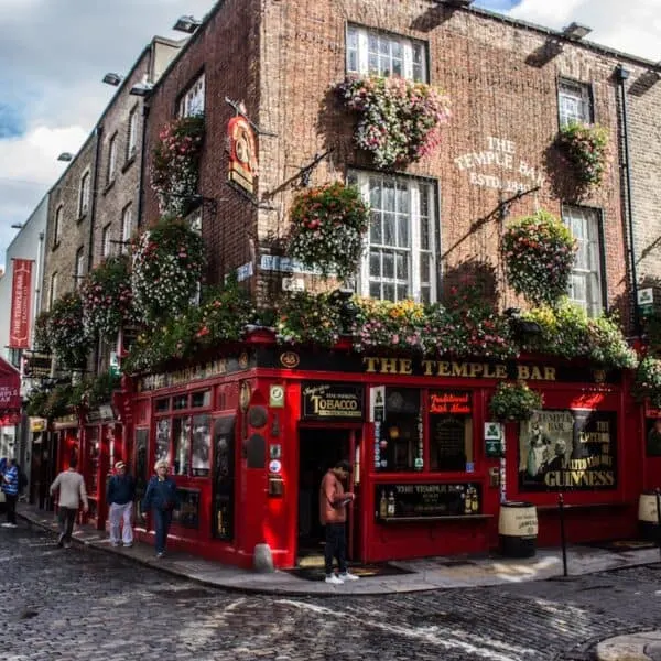 red telephone booth in front of brown concrete building temple bar dublin ireland