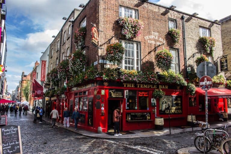 red telephone booth in front of brown concrete building temple bar dublin ireland