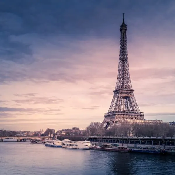tall pointy triangular metal tower near river at sunset, Eiffel Tower, Paris France