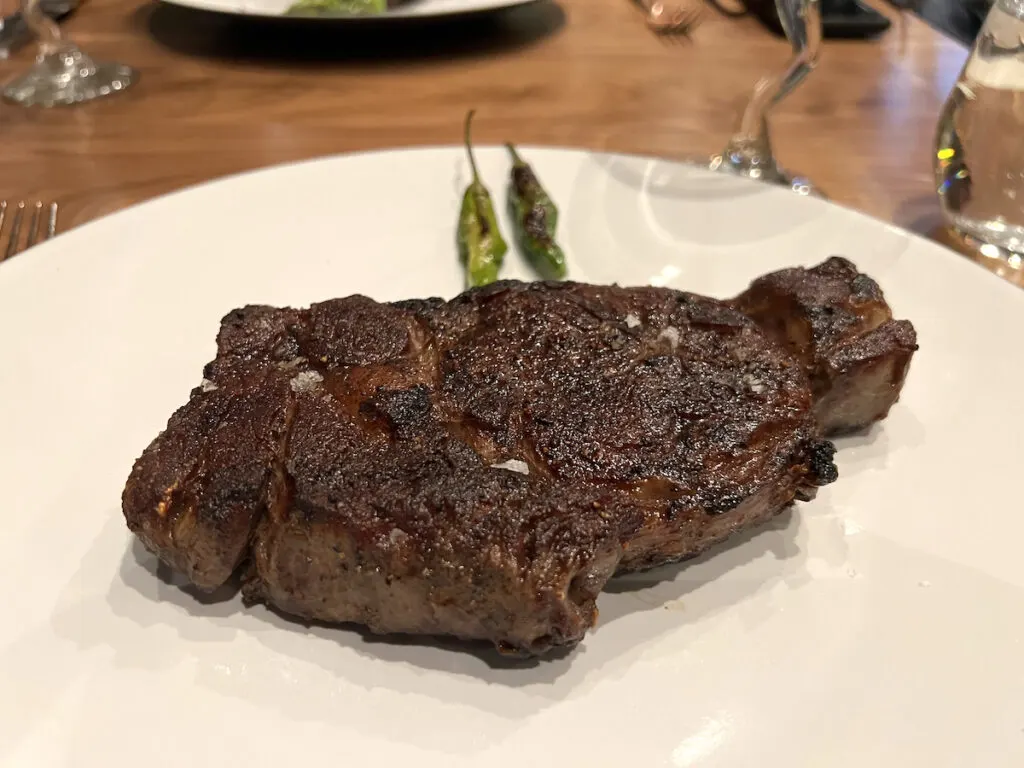 grilled ribeye steak on white plate