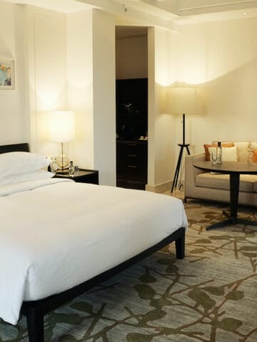 white sheet topped bed in luxury hotel room