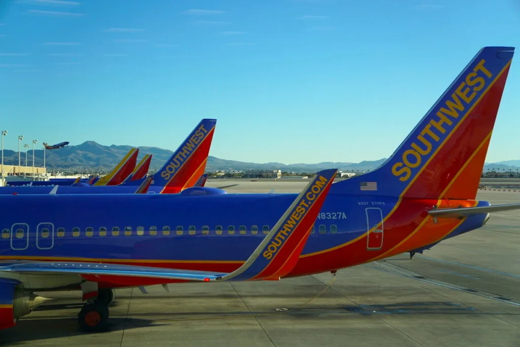 blue and orange planes on airport runaway, southwest airlines