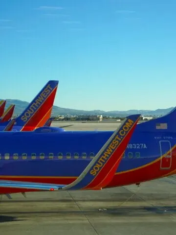 blue and orange planes on airport runaway, southwest airlines