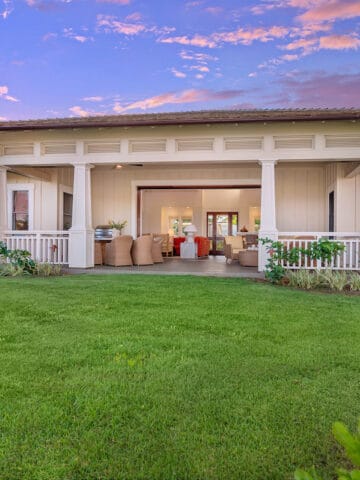 large white villa overlooking expansive green grass