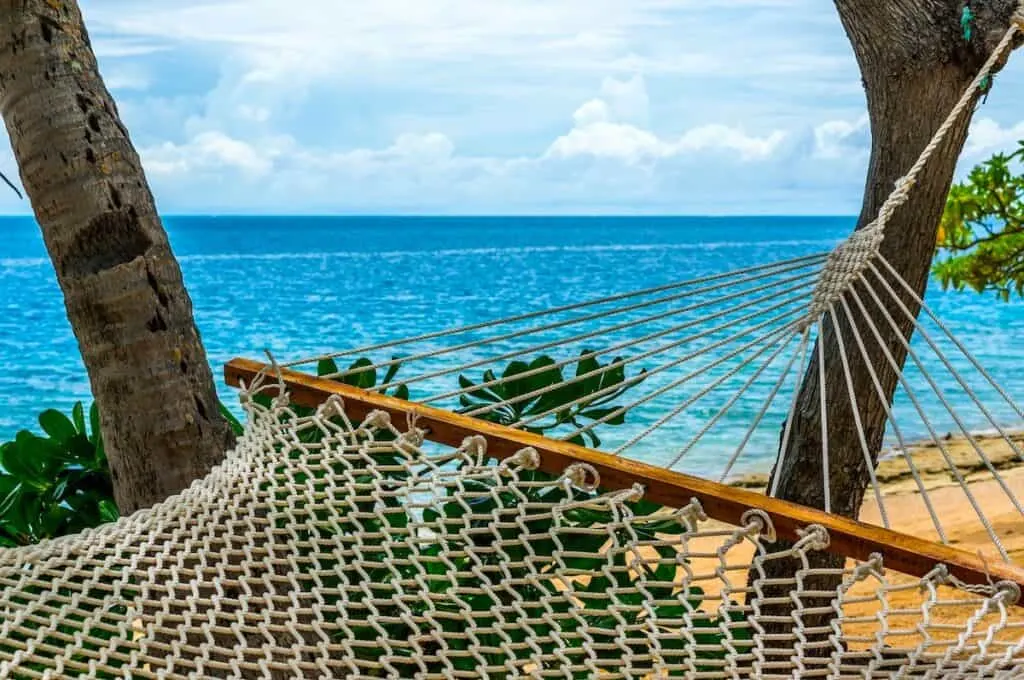 white hammock tied to tree overlooking blue ocean, Malolo Island Fiji