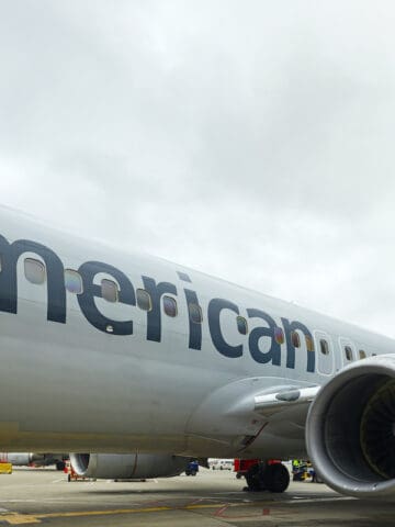 Gray plane on airport tarmac with the word American on left side